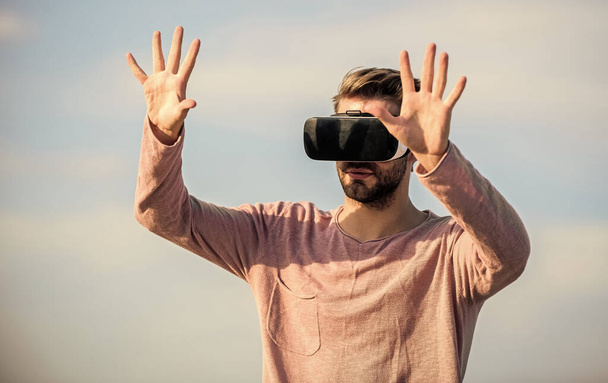 macho man wear wireless VR glasses. Enjoying new experience. Digital future and innovation. guy virtual reality goggles. sexy man sky background vr glasses. male reality. looking so modern - Φωτογραφία, εικόνα