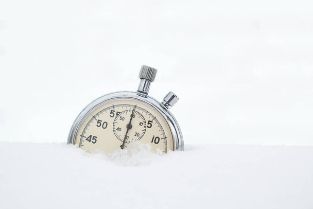 Fallen in the snow, in winter, stopwatch on a white background - Foto, Imagen