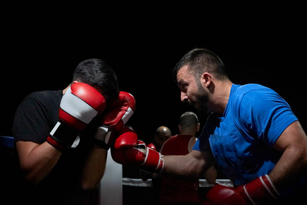 Two boxers training on a gym ring - Photo, Image