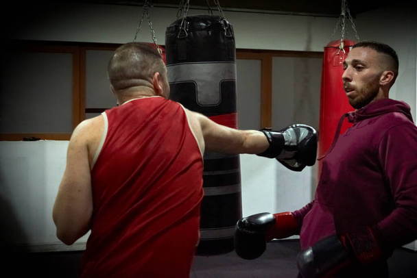 Determined male boxers practicing in health club - Photo, Image