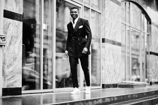 Portrait of young and handsome african american businessman in suit and white sneakers. - Foto, immagini