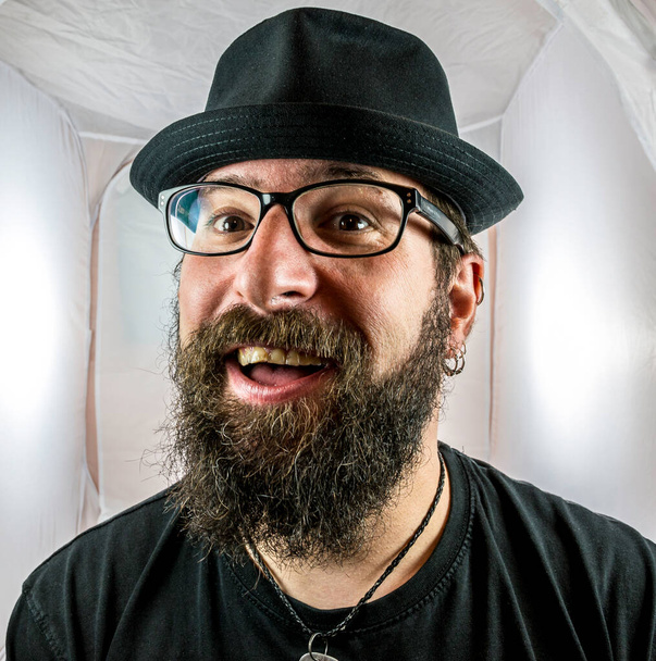 A bearded smiling man in a good mood with black glasses - Photo, Image