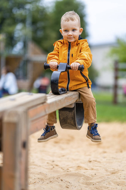 Little Boy Confused on Seesaw Swings - First Day in Playground - Foto, Bild