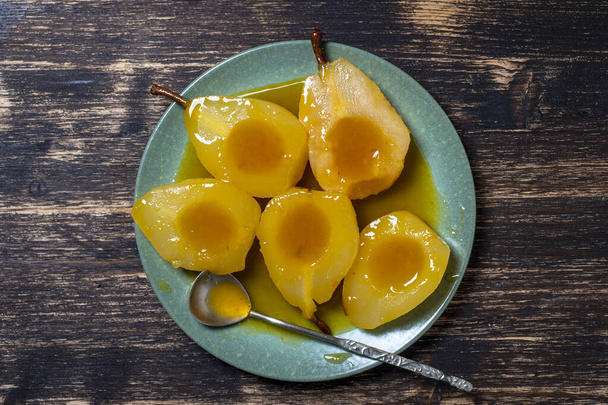 Baked pears in orange juice, close up, top view. Delicious dessert. - Photo, Image