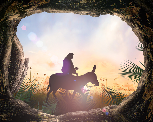 Koncepcja Niedzieli Palmowej: sylwetka Jezusa Chrystusa na osiołku z nagrobkiem na tle zachodzącego słońca łąki - Zdjęcie, obraz