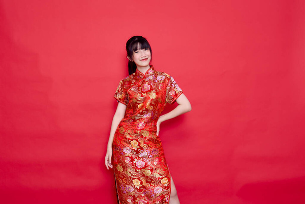 Beauty woman wear cheongsam and smile to you in chinese new year - Photo, Image