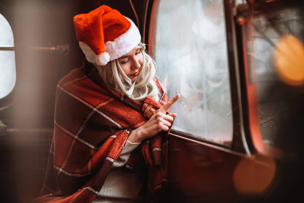 Gorgeous funny girl enjoying new year. Happy girl on Christmas shopping at winter snowy city holiday market, buying souvenirs and gifts, New Year shopping concept.  - Foto, imagen