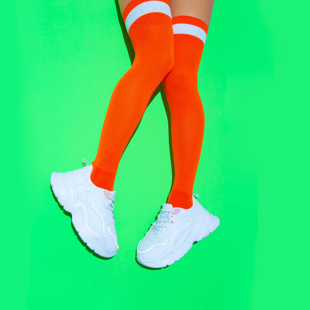 Stylish white Sneakers and vintage sport stockings on fresh green background. Sport fitness summer vibes - Foto, Imagem