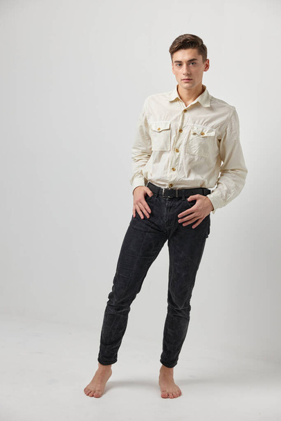 man in wit shirt zwart broek studio lifestyle emoties casual dragen elegante stijl - Foto, afbeelding