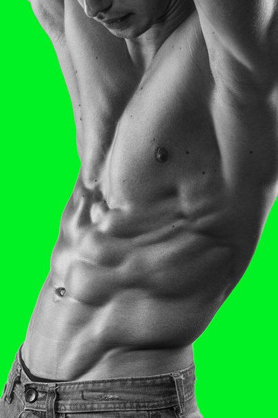 Muscle man poses sexy with shirtless torso, isolated on a green screen chrome key background. - Photo, Image
