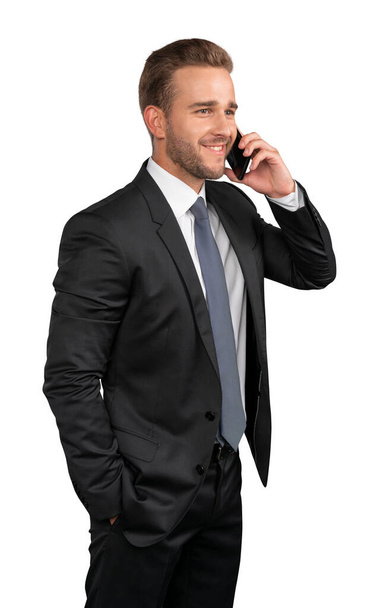 Businessman in suit and tie talking on the phone isolated over white background - Fotografie, Obrázek