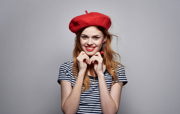 Happy woman in so many emotions headdress earrings makeup striped t-shirt - Foto, afbeelding