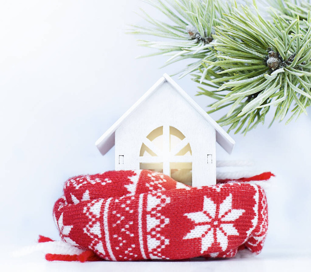 a toy house wrapped in a warm scarf. heating concept - Photo, Image