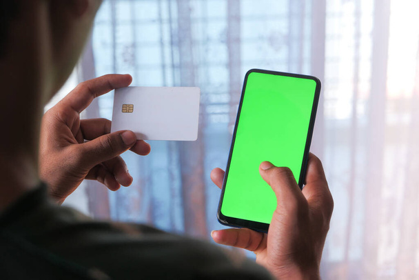 Homem mão segurando cartão de crédito e usando telefone inteligente compras on-line  - Foto, Imagem