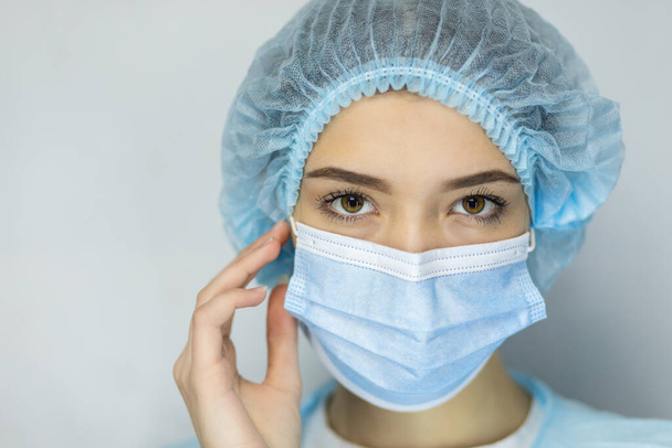 Close up headshot portrait of woman in protective medical mask from coronavirus feel anxious about pandemic, angry worried female wear face cover protecting from covid-19 corona epidemic, infectious - Фото, изображение