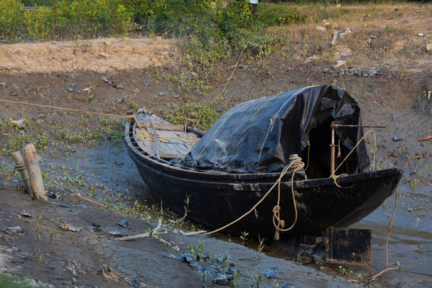 a fisherman boat waiting at the river bank for the tides - Photo, Image