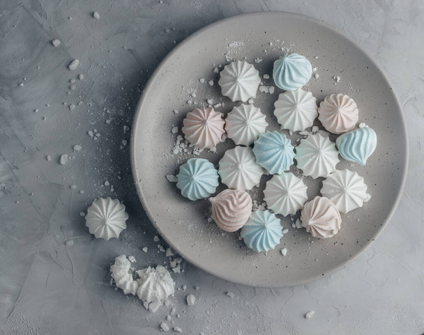 Multicolored meringues on a concrete background. - Foto, afbeelding