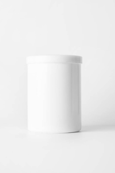 White container with a lid on a light background.. - Photo, Image