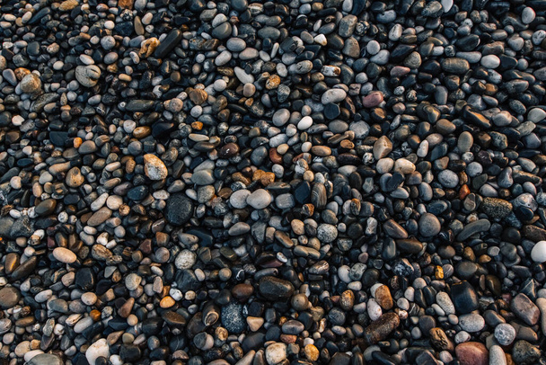 Gravel pattern of wet colored stones. Abstract nature pebbles background. Stone background. Sea peblles beach. Top view. - Fotografie, Obrázek