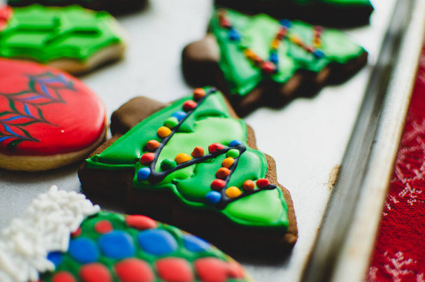 Close-up of a beautifully decorated gingerbread Christmas cookie made to look like a lit-up Christmas tree - Фото, изображение
