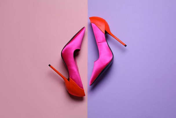 Pair of beautiful shoes on color background, top view - Fotó, kép