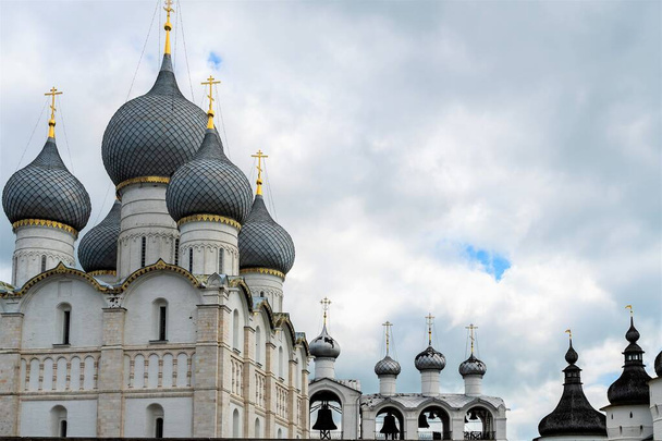 Russia, Rostov, July 2020. Bells and domes of churches against the background of the cloudy sky. - Valokuva, kuva
