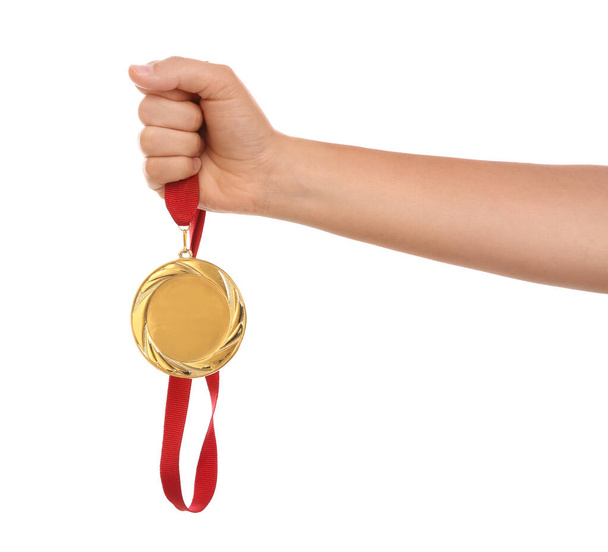 Woman holding gold medal on white background, closeup - Photo, Image