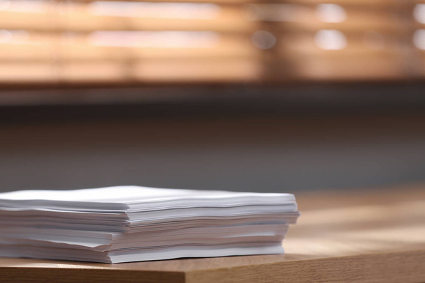 Stack of blank paper on wooden table indoors. Space for text - Fotoğraf, Görsel