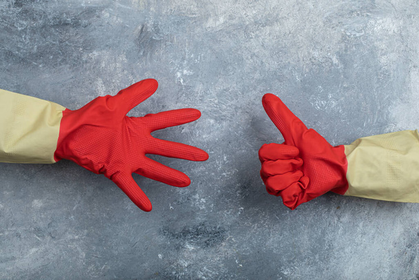 Hands in red protective gloves giving thumbs up - Photo, Image