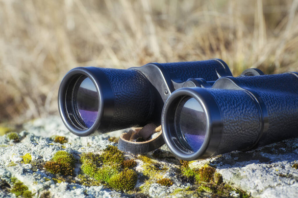 Binoculars on the stone in the steppe in the summer. Closeup photo. - Foto, Imagem