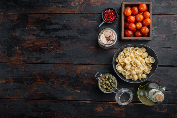 Pasta salad with tuna ingredient, on dark wooden background, top view  with copy space for text - Photo, Image