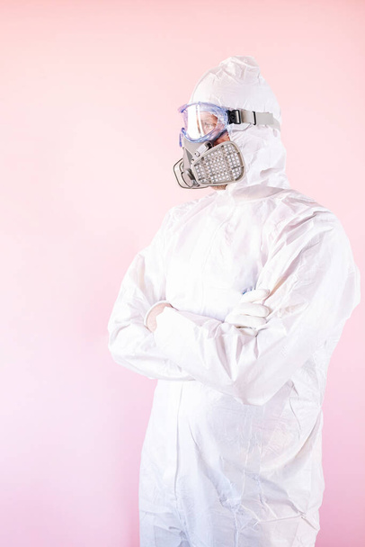 Portrait of male nurse wearing protective suit and work clothes, putting on protective goggles and mask - Foto, immagini