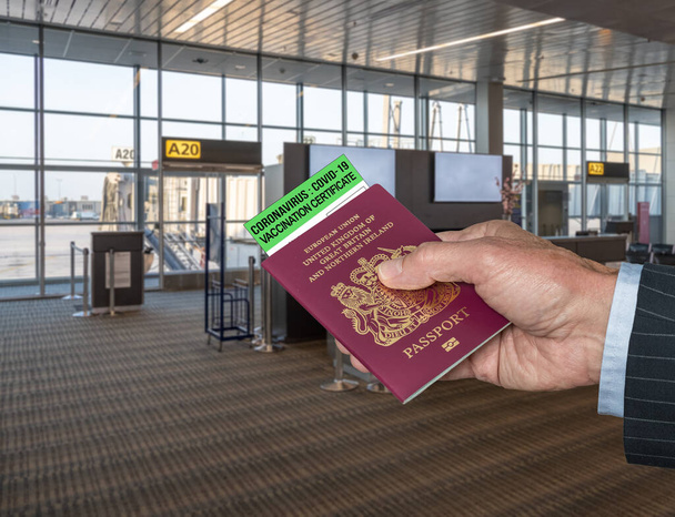 Concept of Covid-19 immune certificate and UK passport to show vaccination for virus at airport - Photo, Image