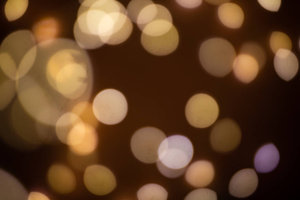 Golden abstract bokeh on a black background, bright lights - Фото, зображення