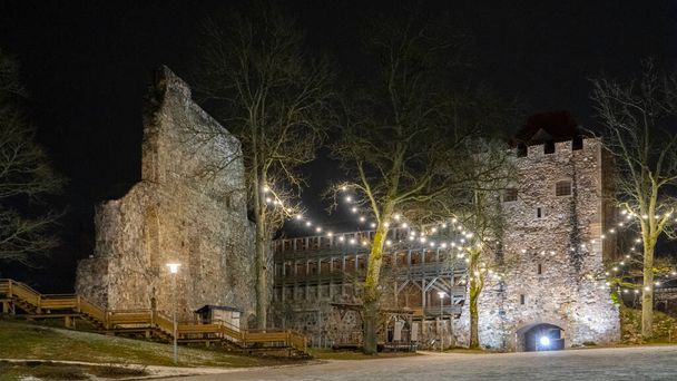 Zřícenina středověkého hradu Sigulda v Lotyšsku. Stará pevnost vánoční čas noc shot. - Fotografie, Obrázek