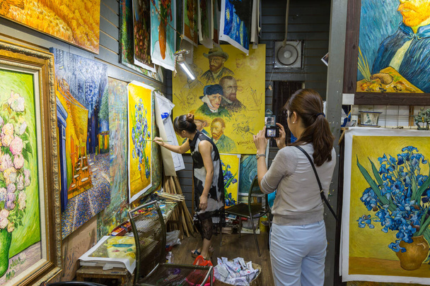 Tourist  taking picture for painter who is painting a Vincent van Gogh's famous work in Dafen Oil painting village of Shenzhen, China - Foto, Imagem