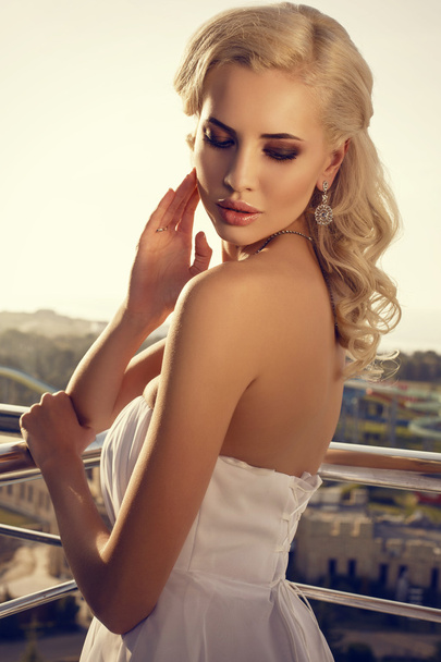 beautiful bride with blond hair posing at the balcony - Фото, зображення
