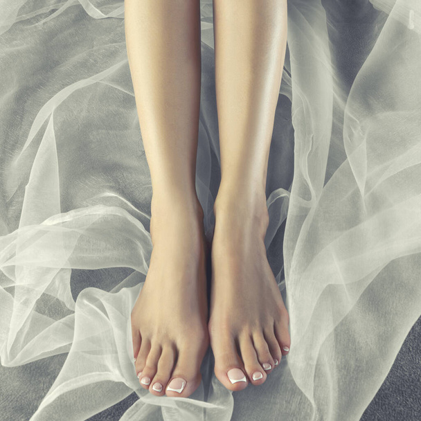 Female legs with pedicure, healthy skin. Spa foot and body care health concept  - Foto, immagini