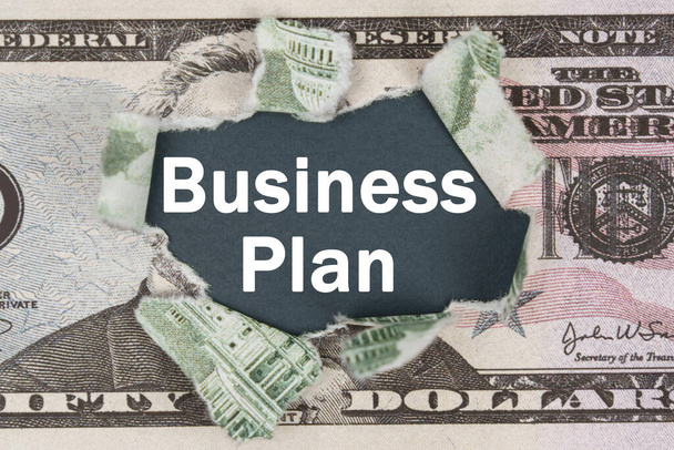 Business and finance concept. The dollar is torn in the center. In the center it is written - Business Plan - Fotó, kép