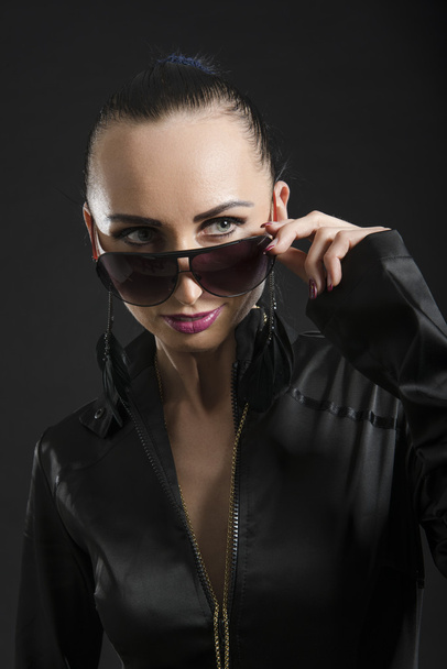 Pretty Caucasian woman in black leather catsuit - Фото, изображение
