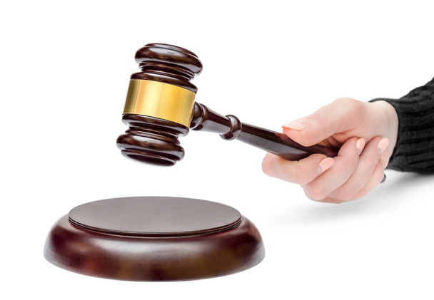Female's hand holding judge's gavel over stand. Law concept. - Photo, Image