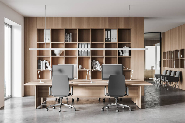 Interior of stylish open space office with white walls, concrete floor, computer tables and bookcase. 3d rendering - Zdjęcie, obraz
