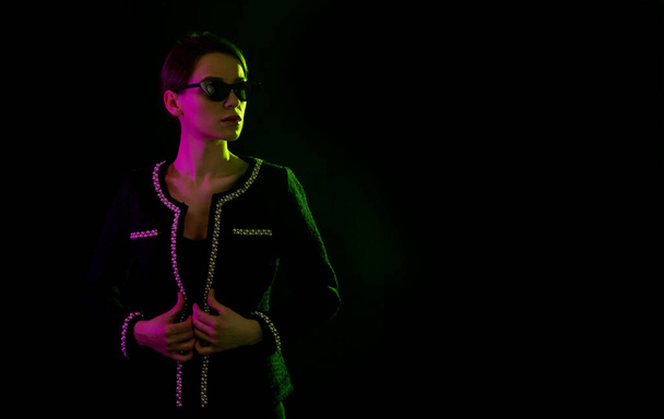 Fashionable woman in pink and green neon lighting. Cyberpunk light. - Photo, image