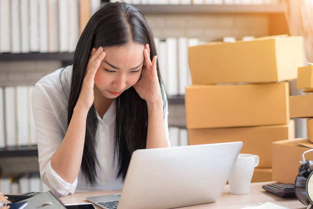 Young Asian woman stress with her business online shopping at office.  - Fotó, kép