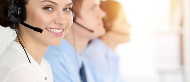 Call center. Diverse customer service operators in headsets at work in office. Business concept - Фото, зображення