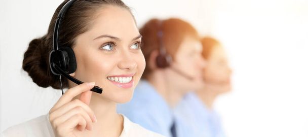 Call center. Diverse customer service operators in headsets at work in office. Business concept - Photo, Image