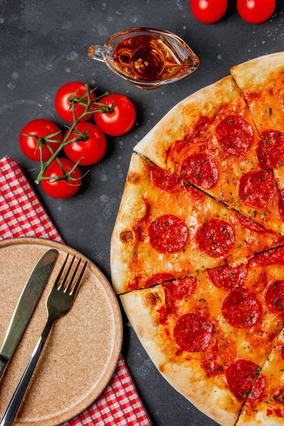  Classic Italian pepperoni pizza and empty plate, top view, vertical photo - Foto, Imagem