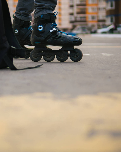 Close-up of roller skates on feet . Man on roller skates - Photo, Image