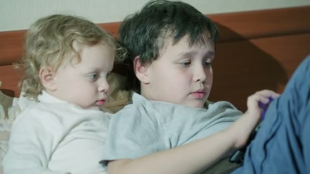 Two young children playing with a tablet - Footage, Video
