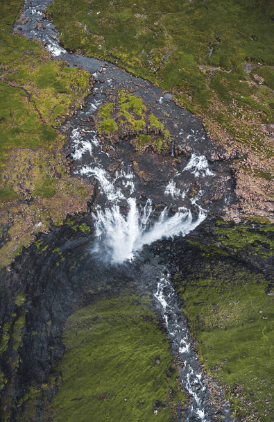 Aerial view of Fossa Waterfall, the highest waterfall in the Faroe Islands. This double-tiered waterfall is 459 feet high and cascades down into the sea. - Foto, imagen